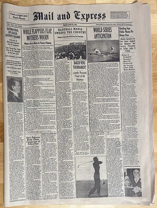 a reproduction vintage newspaper sitting on a table